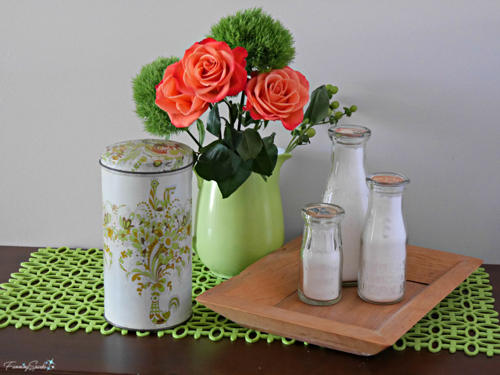 Vintage rusk container displayed with vintage milk bottles, green pitcher and orange roses. @FanningSparks