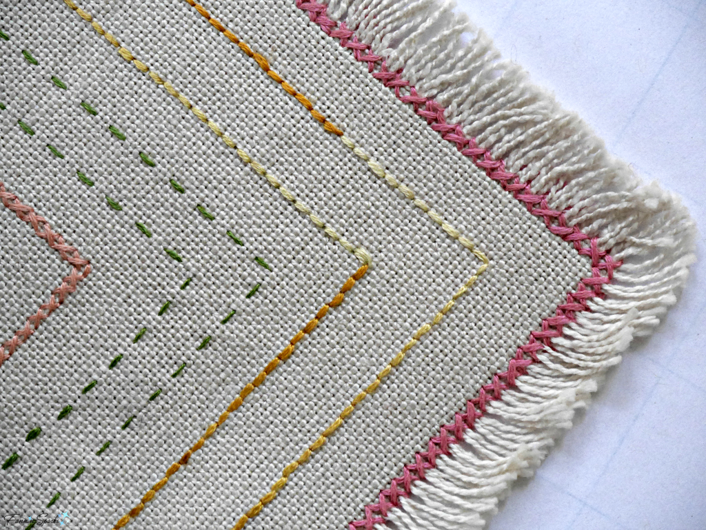 Beginner embroidery sampler showing closeup of cross and running stitches. @FanningSparks