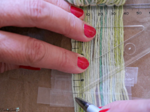 Marking fringe for a clean angled cut on the DIY woven statement necklace. @FanningSparks