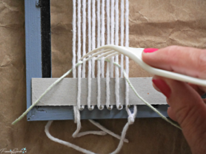 Using plastic fork to settle yarn into place on the DIY woven statement necklace. @FanningSparks