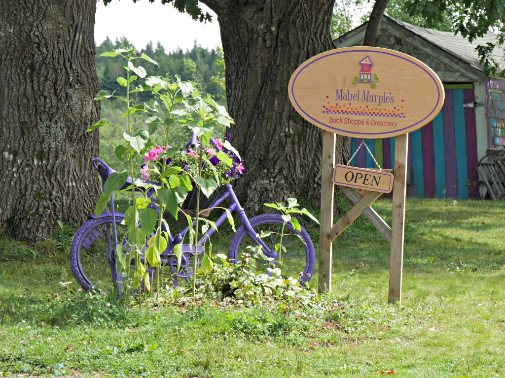 Welcome Sign with Mabel Murple's Purple Bike in River John Nova Scotia. @FanningSparks