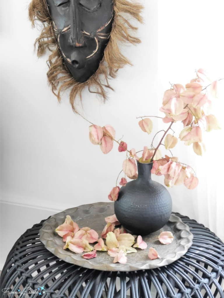 Vignette of Woven Side Table, Carved Mask, Vase and Dried Flowers.   @FanningSparks