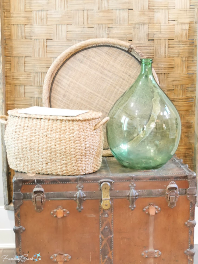 Vignette of Vintage Suitcase, Woven Basket, Tray and Wall Hanging with Green Glass Bottle.   @FanningSparks