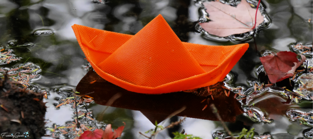 Orange Boat Floating Amongst Autumn Leaves in Nova Scotia @FanningSparks