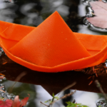 Orange Boat Floating Amongst Autumn Leaves in Nova Scotia @FanningSparks