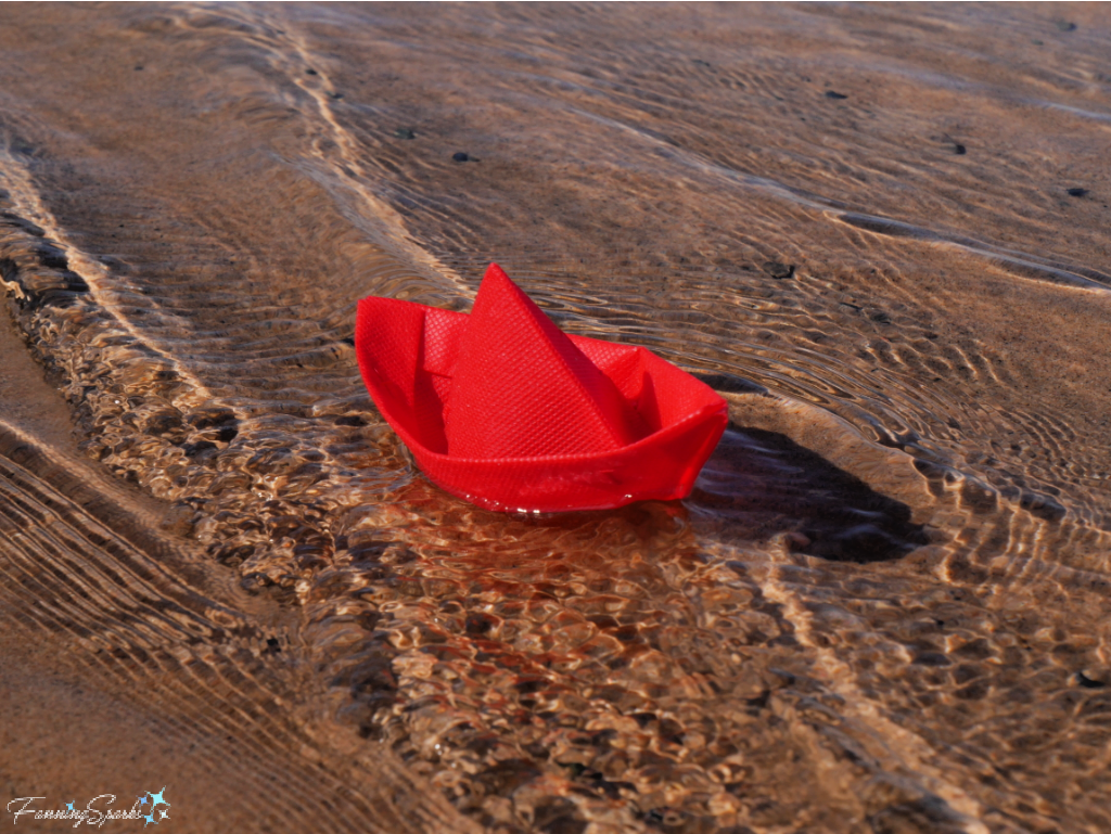 Red Folded Boat in Waves    @FanningSparks