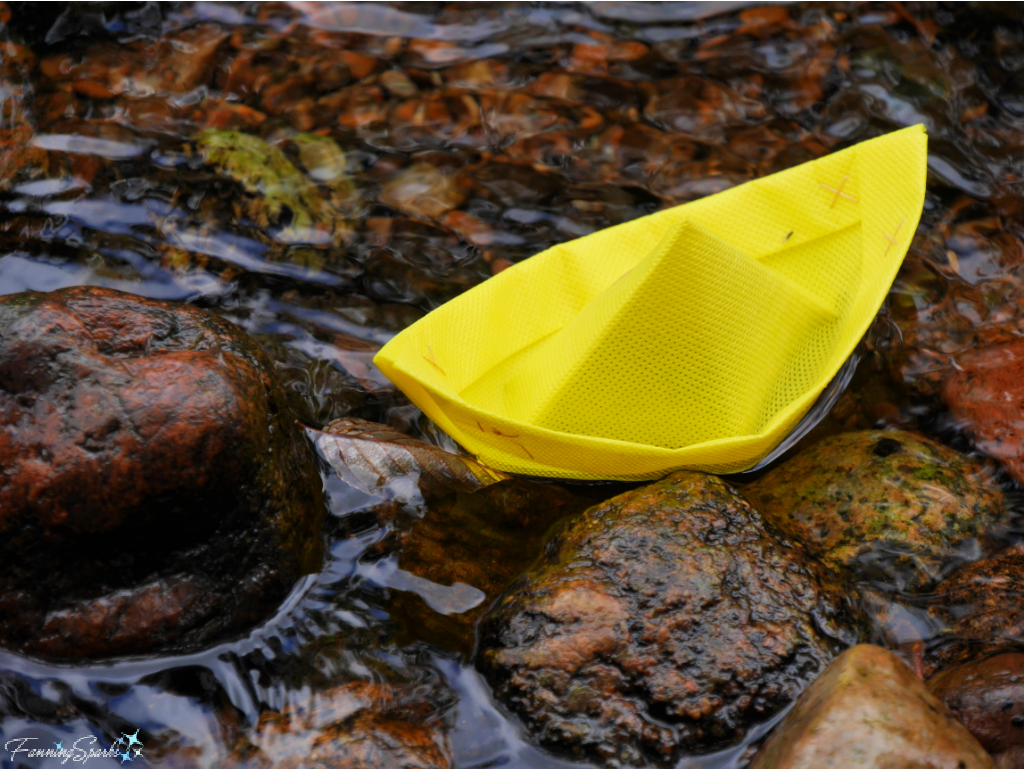 Yellow Folded Boat in Stream with Rocks    @FanningSparks