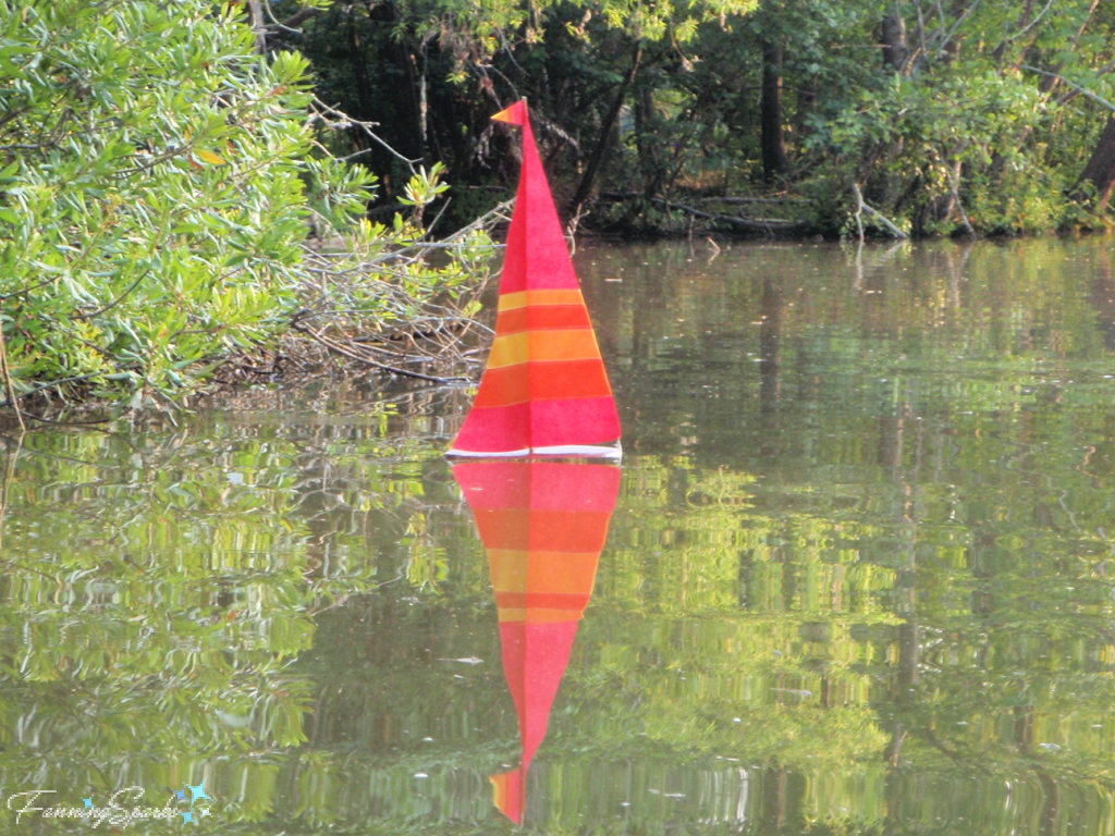 Red, Orange and Yellow Striped Sailboat in Lake Oconee   @FanningSparks